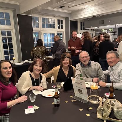 Quinn & Wilson team and friends gathered around a table